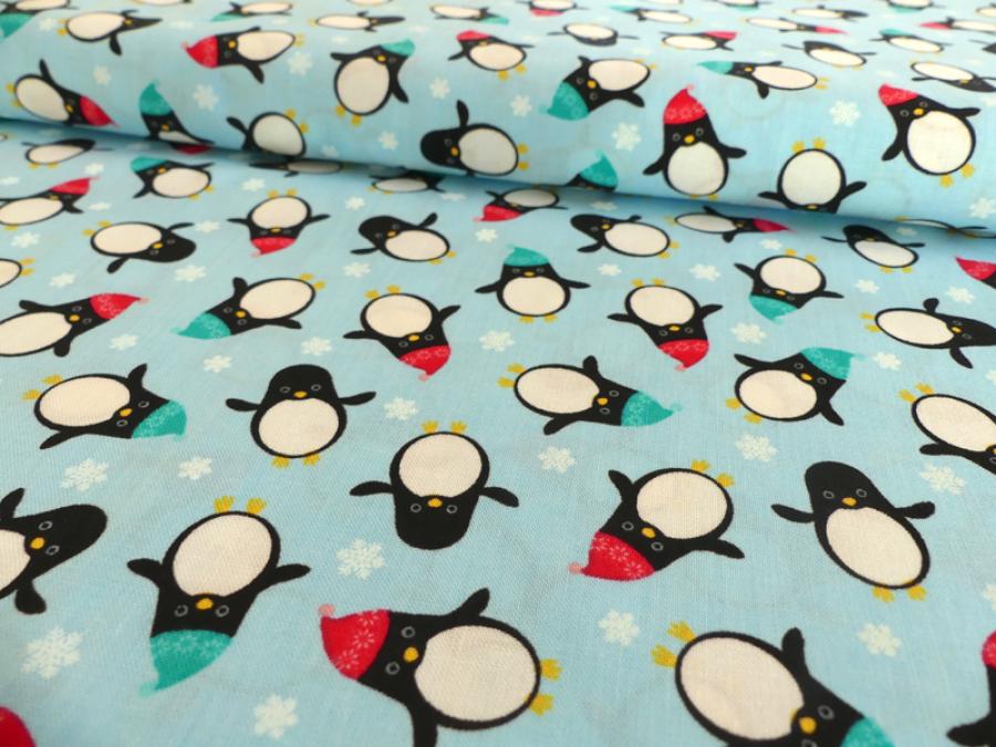 Patchworkstoff Pinguine mit Mütze auf helltürkis. Von Timeless Treasures.